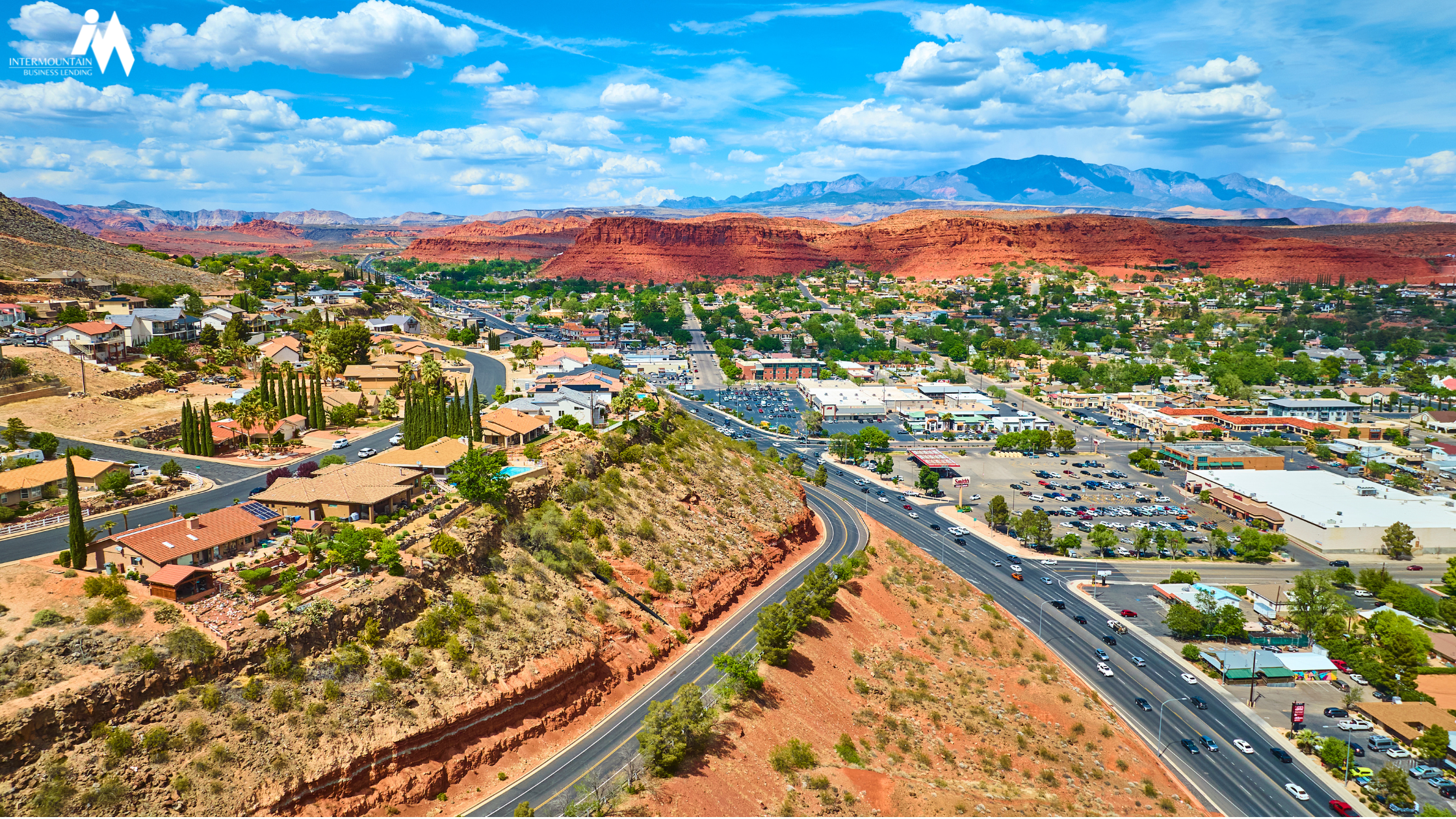 sba 504 St. George utah Aerial view of St. George, Utah showing commercial buildings with red rock cliffs in the background